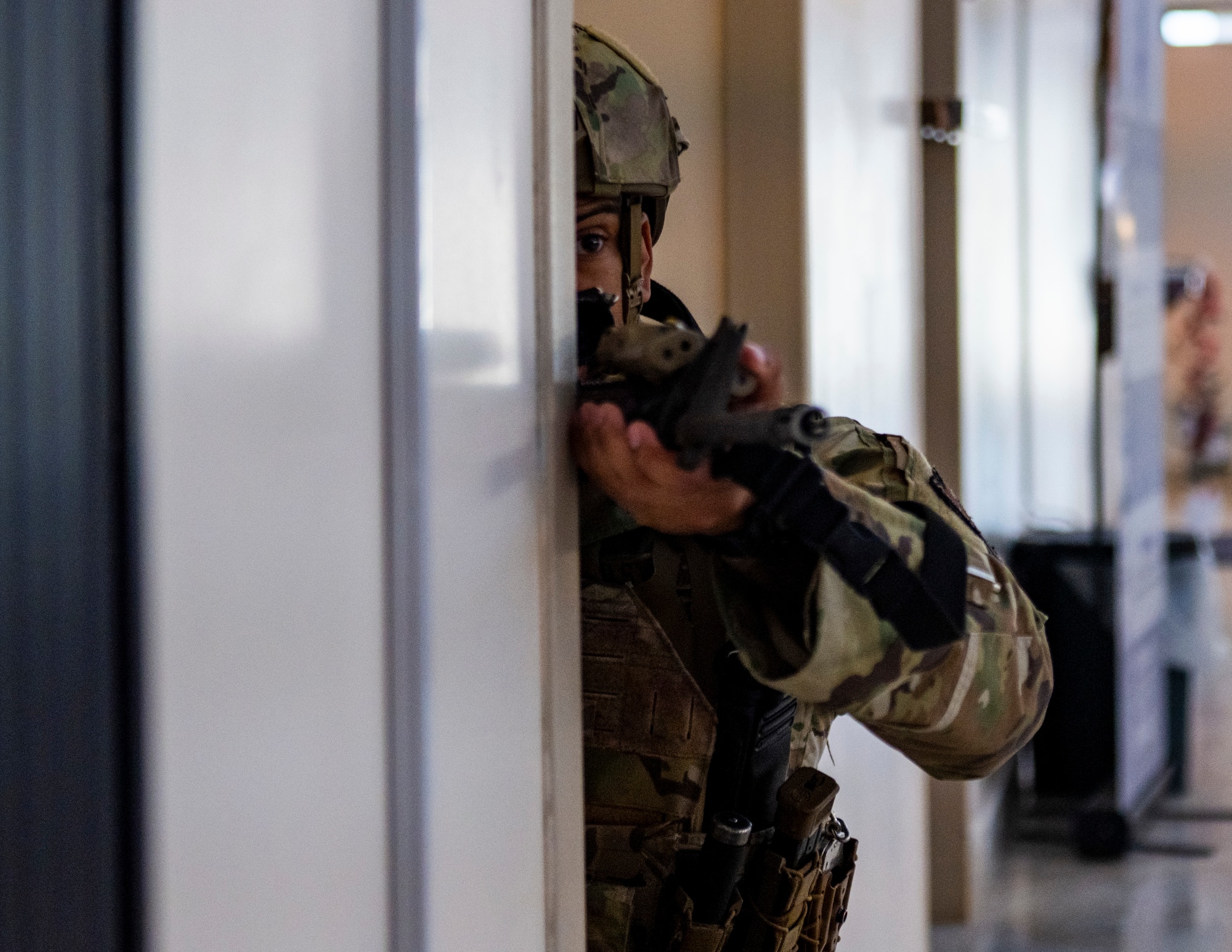 A service member maintains a defensive position