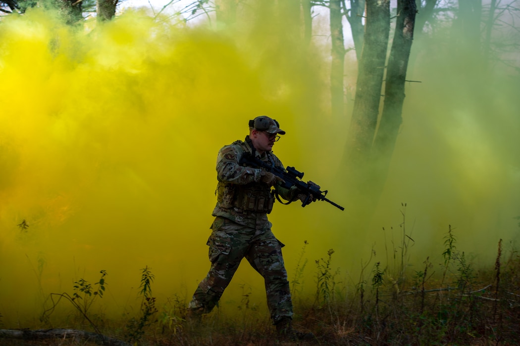 Staff Sgt. Tyler Emerson, a member of the 101st Security Forces Squadron, emerges from a smoke screen as part of the 101st's Air Base Ground Defense Training Oct. 19th, 2025, 101st Air Refueling Wing, Bangor, Maine.