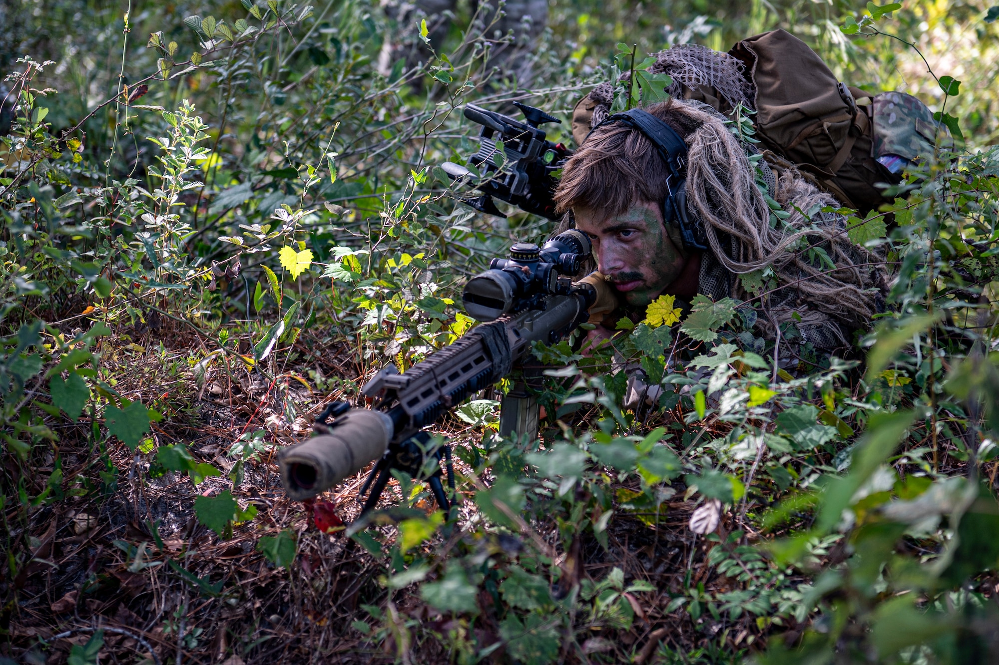 A U.S. Air Force Airman assigned to the 822nd Base Defense Squadron looks through the scope of his rifle during Exercise IRON SAFESIDE at Moody Air Force Base, Georgia, Oct. 3, 2025. The training strengthened core security operations skills, ensuring defenders remain ready to respond effectively in contested environments. (U.S. Air Force photo by Senior Airman Leonid Soubbotine)