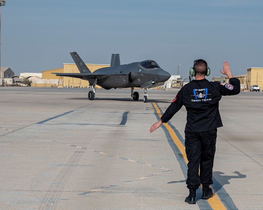 U.S. Air Force Staff Sgt. Jacob Sackett, a dedicated crew chief assigned to the F-35A Lightning II Demonstration Team, marshals an F-35A Lightning II after landing at Al Dhafra Air Base, United Arab Emirates, on Nov. 17, 2025. The team preformed at the Dubai Airshow to showcase the capabilities of the F-35A to nations around the globe. (U.S. Air Force photo by Staff Sgt. Nicholas Rupiper)