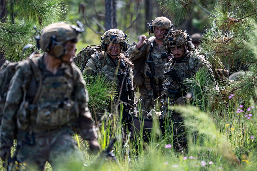 822nd Base Defense Squadron carry a simulated casualty to safety during Exercise IRON SAFESIDE at Moody Air Force Base, Georgia, Oct. 3, 2025. The exercise challenged defenders to balance speed, communication and maintaining security, while evacuating wounded teammates under pressure. (U.S. Air Force photo by Senior Airman Leonid Soubbotine)