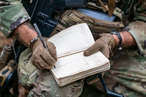 A U.S. Air Force Airman assigned to the 822nd Base Defense Squadron fills out an evacuation form during EXERCISE IRON SAFESIDE at Moody Air Force Base, Georgia, Oct. 3, 2025. The drill emphasized accurate reporting procedures and coordination to support efficient medical evacuations in the field. (U.S. Air Force photo by Senior Airman Leonid Soubbotine)
