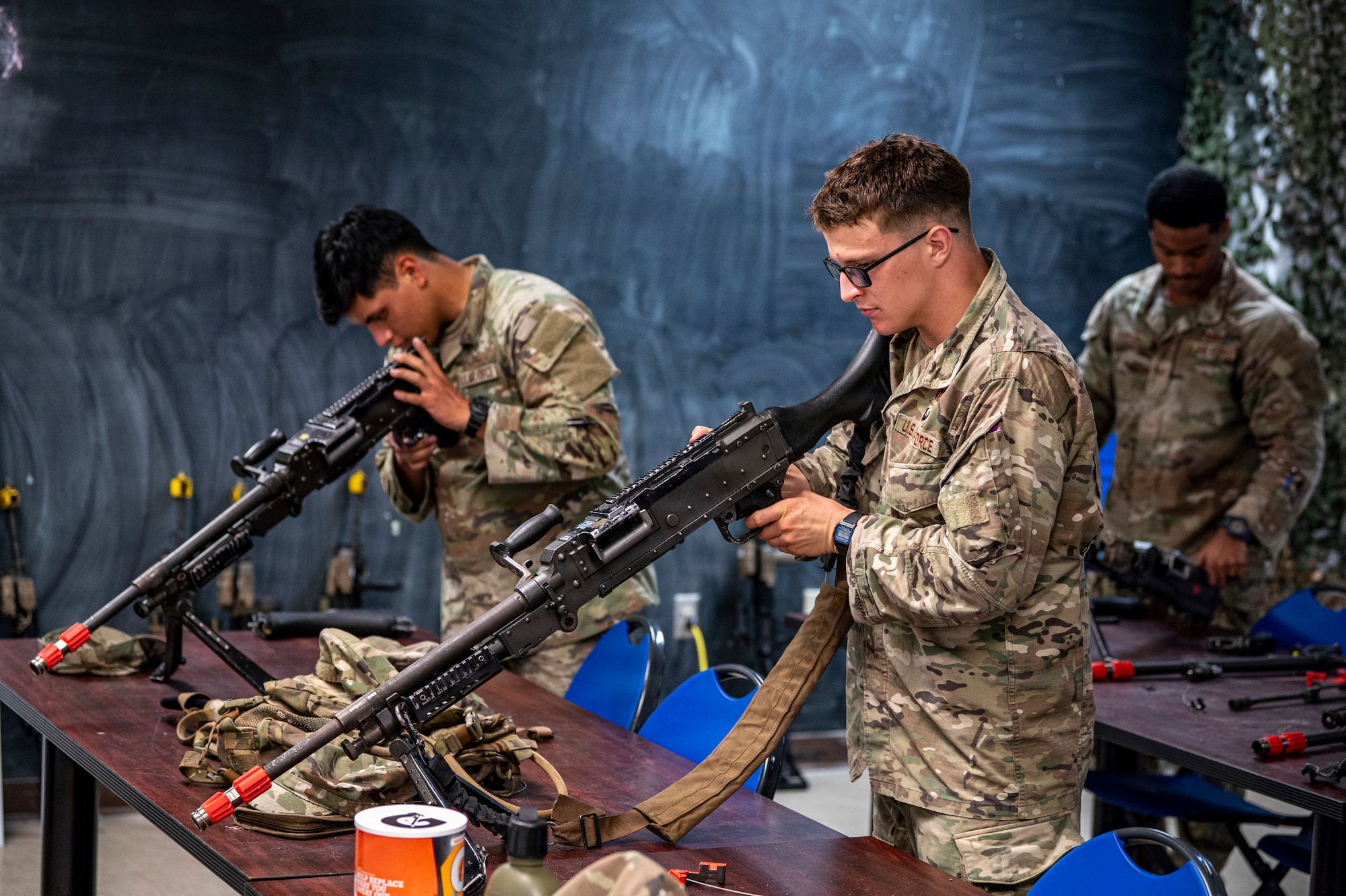 U.S. Air Force Airmen assigned to the 820th Base Defense Group assemble M240 machine guns at Moody Air Force Base, Georgia, Oct. 7, 2025. The hands-on training was part of the Ranger Assessment and Preparation Course, where Defenders refined their weapons handling, reassembly speed and attention to detail skills while under pressure. (U.S. Air Force photo by Senior Airman Leonid Soubbotine)