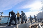 U.S. Navy Sailors assigned to Arleigh Burke-class guided-missile destroyer USS Paul Ignatius (DDG 117) heave a mooring line as the ship arrives in Toulon, France, Nov. 20, 2025. Paul Ignatius is on a scheduled deployment in the U.S. 6th Fleet area of operations to support the warfighting effectiveness, lethality and readiness of U.S. Naval Forces Europe-Africa, and defend U.S., Allied and partner interests in the region. (U.S. Navy photo by Mass Communication Specialist 2nd Class Joseph Macklin)