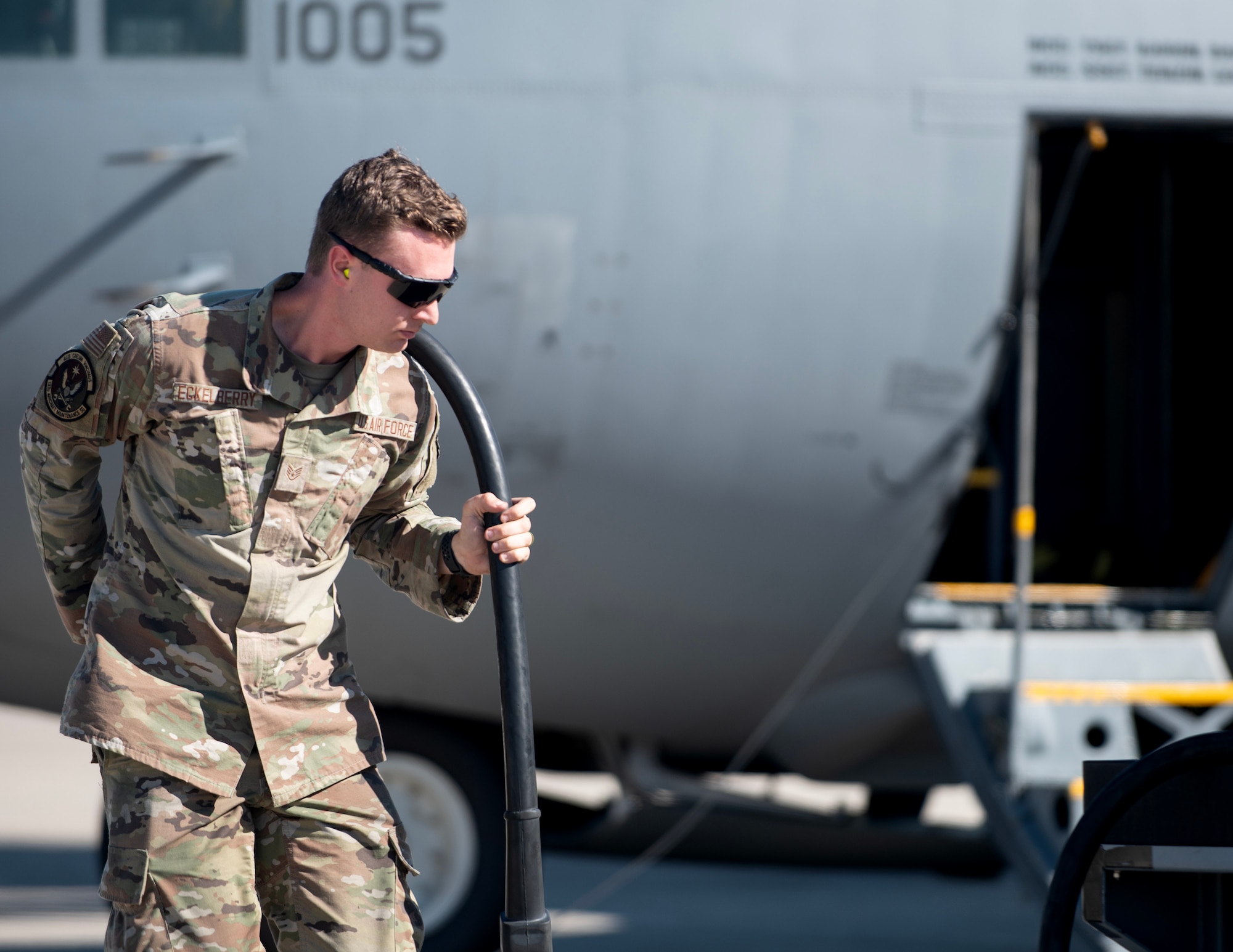 U.S. Air Force Staff Sgt. Joshua Eckelberry, 133rd Maintenance Group, drags an auxiliary power unit cable in St. Paul, Minn., Sept. 24, 2025.