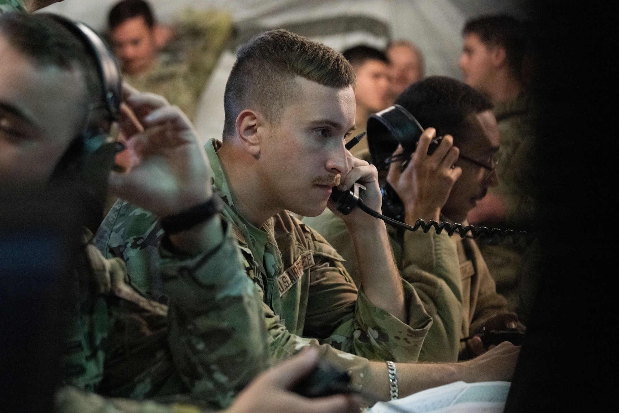 U.S. Air Force Senior Airman Tucker Pettit, a joint communicator assigned to the Joint Communications Support Element (JCSE) listens over a phone using high-frequency radio technology during Exercise Noble Skywave at MacDill Air Force Base, Florida, Oct. 22, 2025. Noble Skywave is an annual, Canadian-led high-frequency radio competition for military units to test and improve their ability to use high-frequency radio technology. JCSE competes to maintain high-frequency expertise and ability to operate in any environment. (U.S. Air Force photo by Airman Alexis Adams)
