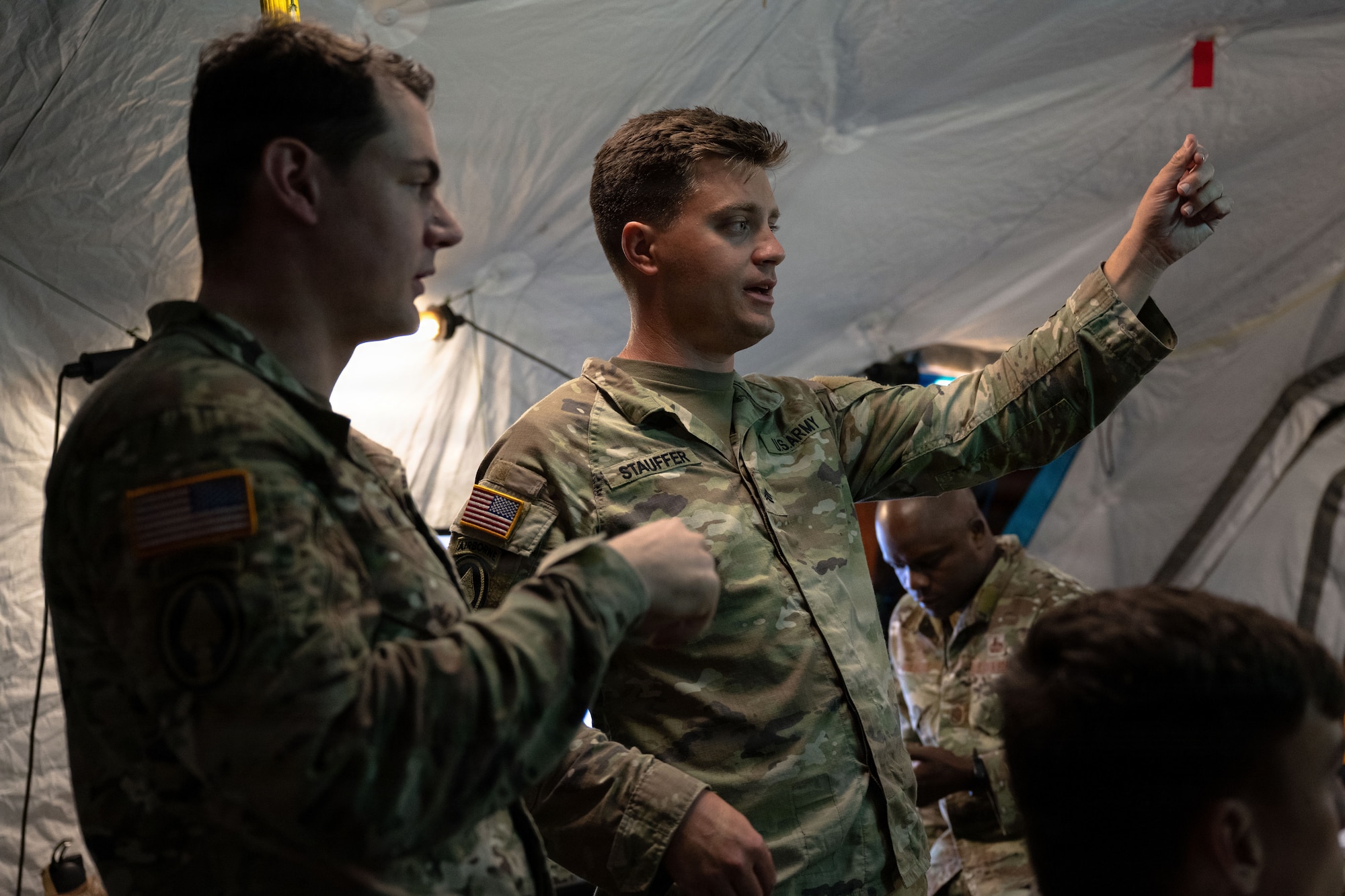 U.S. Army Sgt. James Stauffer, right, and Staff Sgt. Patrick Cook, joint communicators assigned to the Joint Communications Support Element (JCSE), discuss details during Exercise Noble Skywave at MacDill Air Force Base, Florida, Oct. 22, 2025. Noble Skywave is an annual, Canadian-led high-frequency radio competition for military units to test and improve their ability to use high-frequency radio technology. JCSE competes to maintain high-frequency expertise and ability to operate in any environment. (U.S. Air Force photo by Airman Alexis Adams)