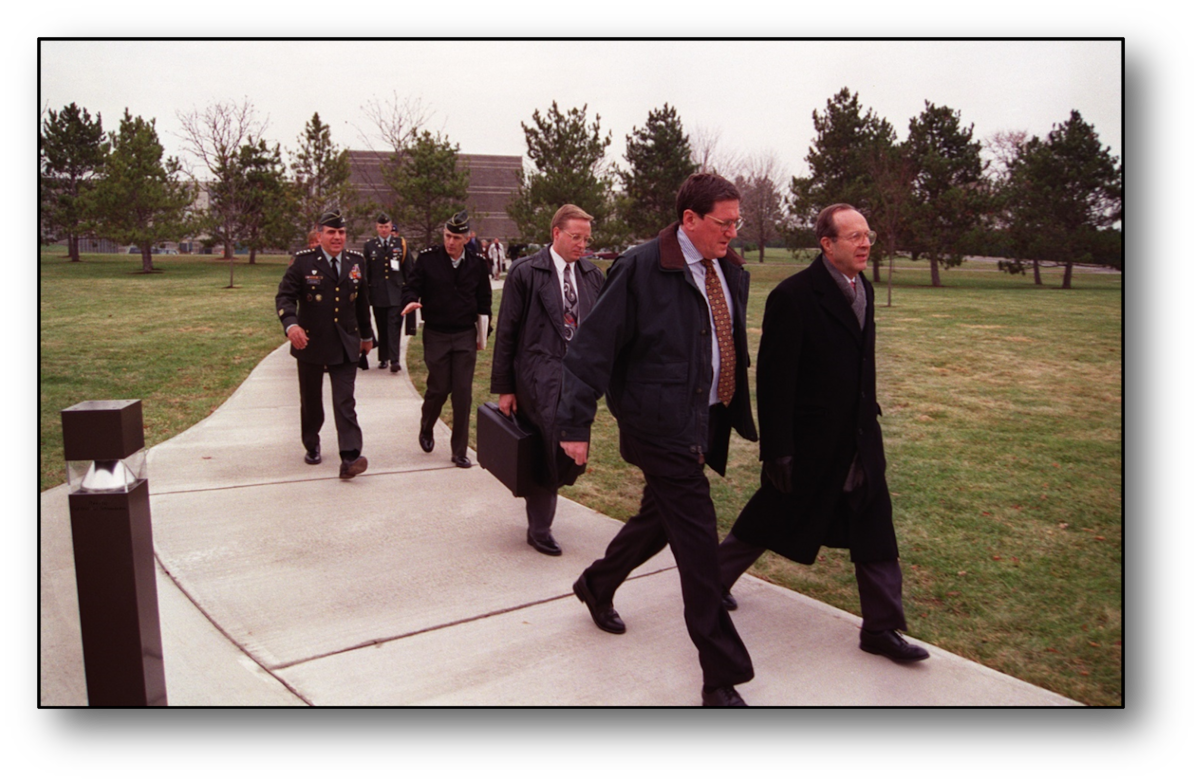 Delegates walk on a sidewalk during Dayton Peace Accords