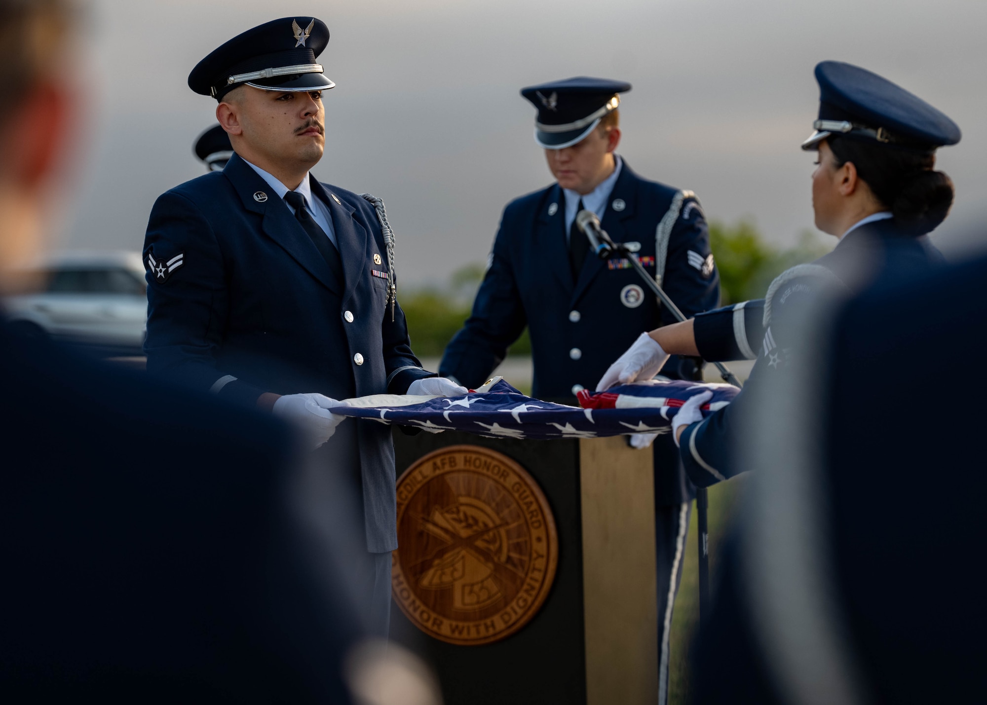 onor guardsmen assigned to the 6th Force Support Squadron, perform a flag fold during an honor guard induction ceremony at MacDill Air Force Base, Florida, Oct. 28, 2025. Flag-folding ceremonies are symbolic displays of respect that have developed into a rich military tradition. Flag handlers fold the American Flag 13 times representing the original colonies of the United States, with each fold carrying its own meaning. The flag is folded into a triangular shape with only the blue starred field showing, representing the states that U.S. veterans served while in uniform. (U.S. Air Force photo by Airman 1st Class Monique Stober)
