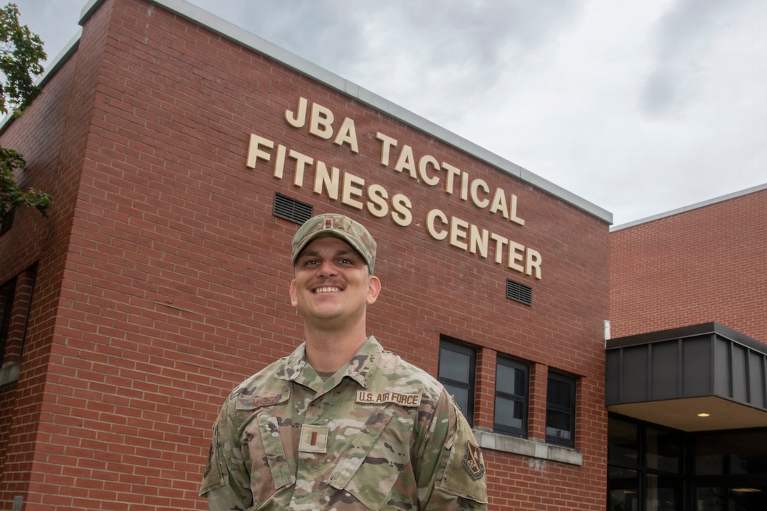 U.S. Air Force 2nd Lt. Dustyn N. Neese, 316th Force Support Squadron sustainment flight commander, poses in front of the Joint Base Andrews Tactical Fitness Center at Joint Base Andrews, Maryland, Aug. 6, 2025. Neese, who enlisted in 2009 and served as a targeting analyst before earning a commission in 2024, oversees both fitness centers on base as well as the dining facility, lodging and mail center.