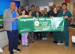 Walter Reed's 3 Center nursing team members and director for nursing services celebrate the unit's recent DAISY Award recipient for extraordinary nursing care, U.S. Army 1st Lt. Jakob Jackson (back row, third from left) at the ward.