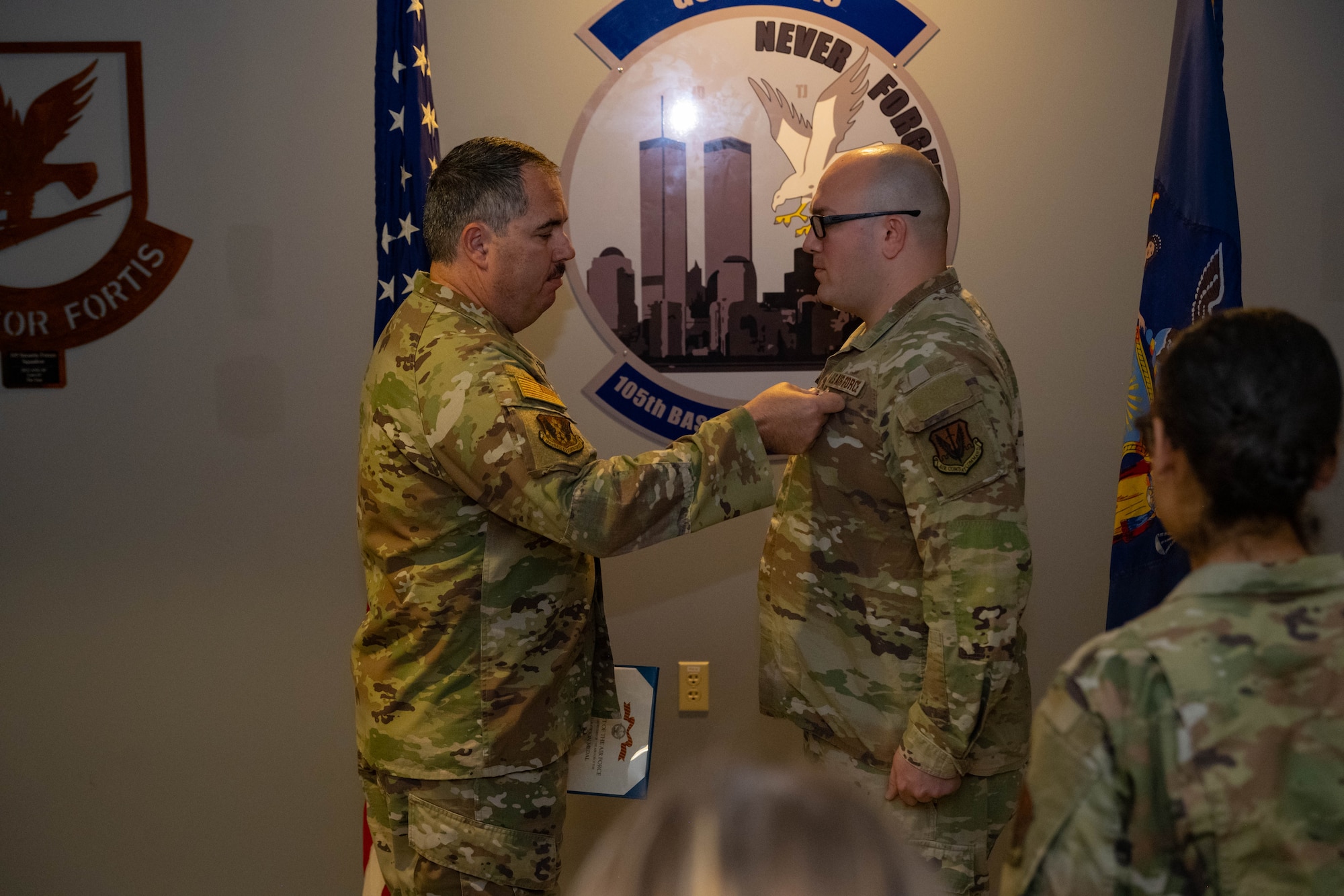 Lt. Col. Michael Curtis awards Tech. Sgt. Devin Miller with the Air Force Combat Action Medal.