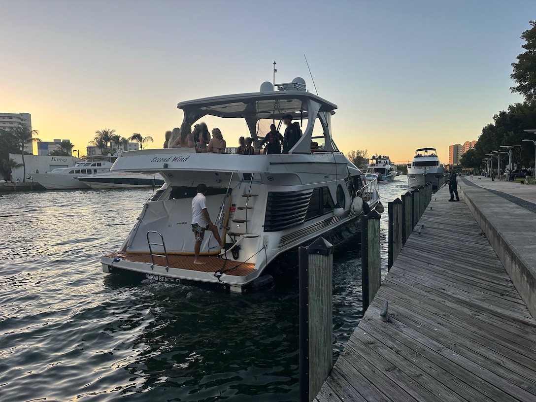 U.S. Coast Guard law enforcement officers board the 52-foot motor vessel Second Wind near Lummus Park, Florida, Nov. 15, 2025. Second Wind was found to be operating as an illegal small passenger vessel, violating an active Captain of the Port order. (U.S. Coast Guard courtesy photo)