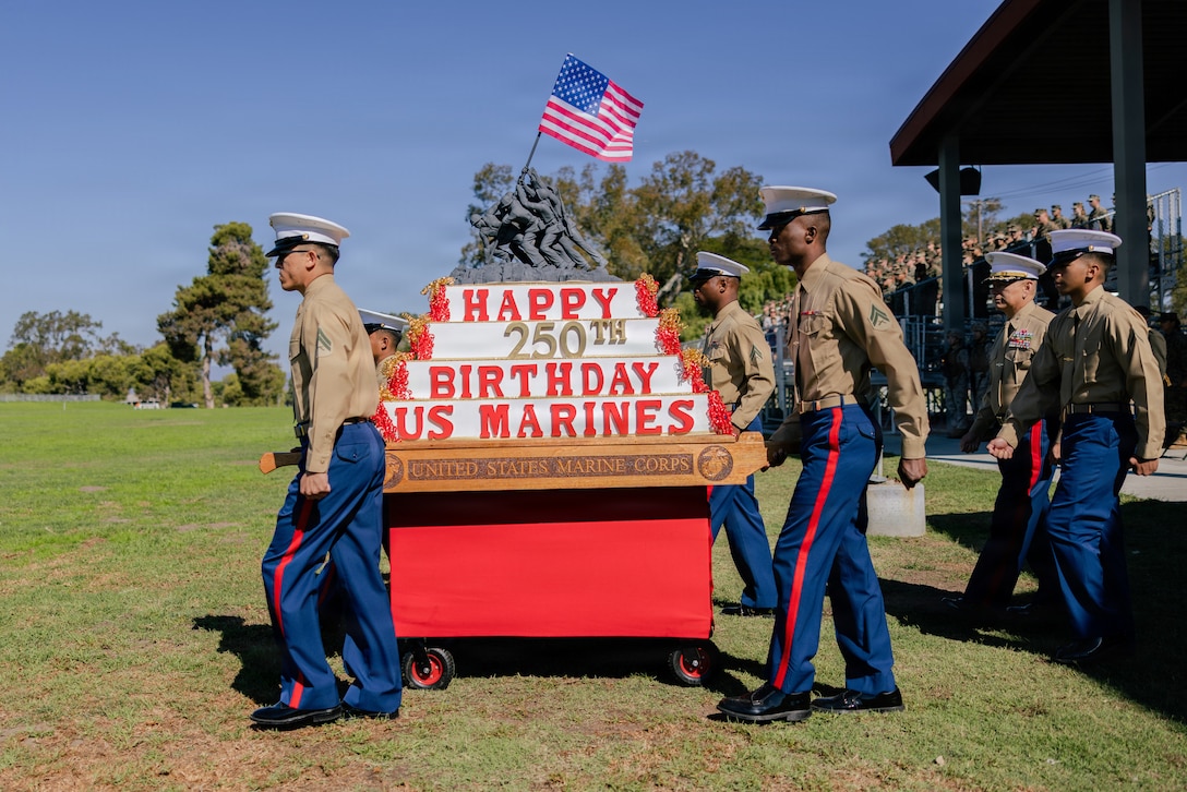 U.S. Marines march out the birthday cake during the Camp Pendleton Annual Marine Corps Birthday Pageant and Cake Cutting Ceremony at Marine Corps Base Camp Pendleton, California, Nov. 6, 2025. The birthday pageant is an annual tradition featuring a uniform pageant and the traditional cake cutting ceremony in honor of the Marine Corps’ 250th birthday. (U.S. Marine Corps photo by Sgt. Edgar Rafael).