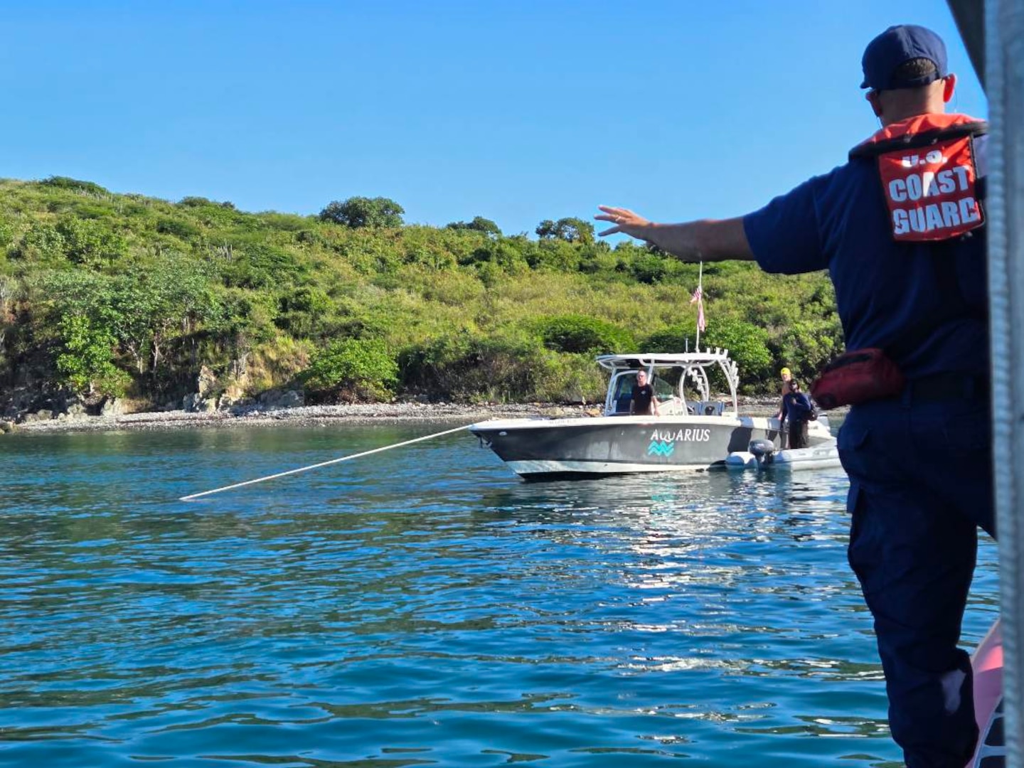 A Coast Guad Boat Forces Unit U.S. Virgin Islands 33-foot Special Craft surface unit is on-scene with the recreational vessel Aquarius during the vessel Cool Change grounding response in the vicinity of Christmas Cove, St. Thomas, U.S. Virgin Islands, Nov. 20, 2025.  The vessel Aquarius rescued the captain of the vessel which remains a ground and partially submerged. (U.S. Coast Guard photo).