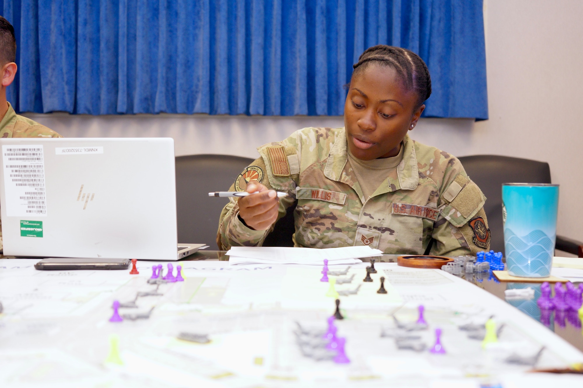 Staff Sgt. Sydney Willis, 735th Air Mobility Squadron special handling supervisor, analyzes airfield movements during a tabletop exercise at Joint Base Pearl Harbor-Hickam, Sept. 25–Oct. 1, 2025