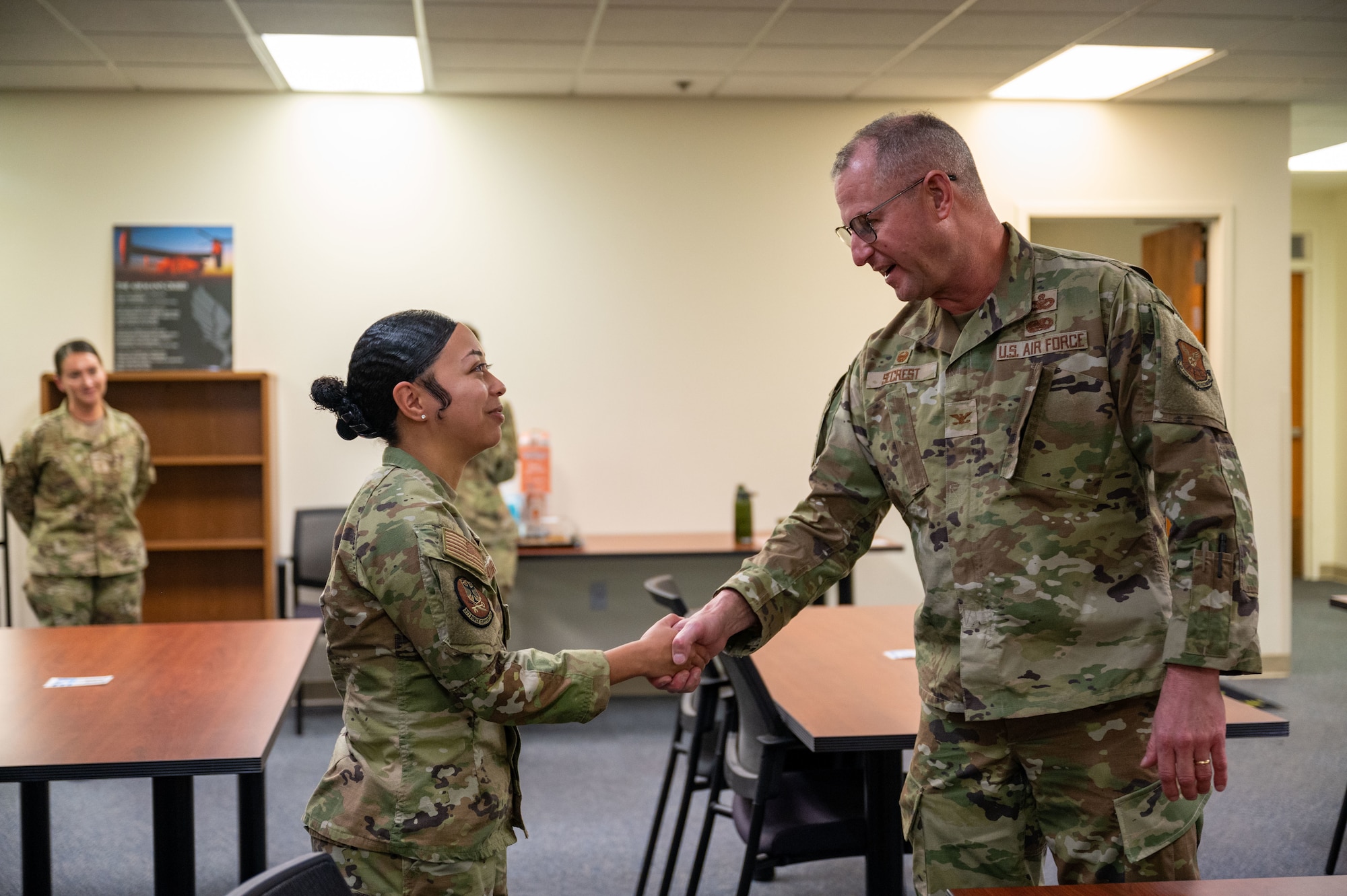 Col Justin Secrest, 377th Air Base Wing commander, recognized outstanding performer, Airman 1st Class Maya Mayor from the 377th Military Personnel Flight, for her exceptional work during the Nuclear Surety Staff Assistance Visit and presented her with the Command Safety Directorate coin at Kirtland Air Force Base, New Mexico, Sept. 30, 2025. The NSSAV is a week-long process in which subject matter experts in the nuclear surety field assess the wing's nuclear surety and training programs prior to an upcoming Initial Nuclear Surety Inspection and NSI. (U.S. Air Force photo by Technical Sgt. Gabrielle Winn)