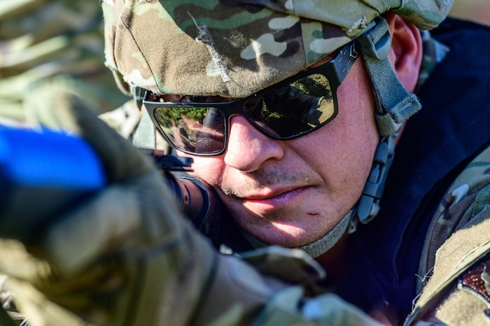 Airman aims weapon.