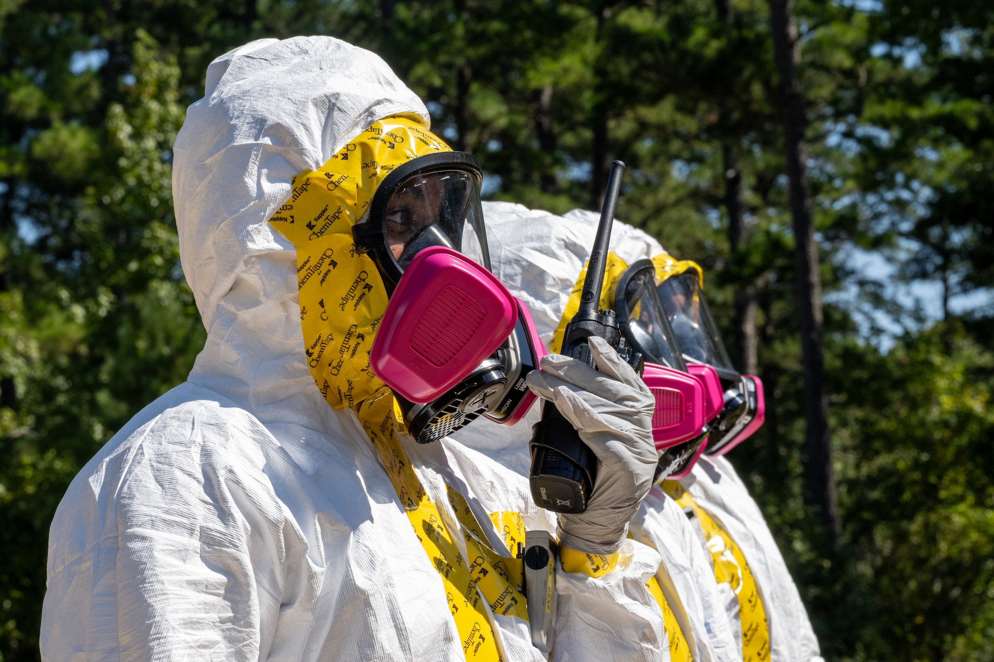 U.S. Air Force Airman 1st Class Raeven Anothony, 2nd Operational Medical Readiness Squadron bioenvironmental engineering technician, uses a walkie-talkie during a simulated nuclear response training at Barksdale Air Force Base, Louisiana, Oct. 1, 2025. Bioenvironmental engineering personnel participated in a radiation response training event focusing on dose management, monitoring and recovery procedures for potentially contaminated aircraft. (U.S. Air Force photo by Airman 1st Class Devyn Taylor)