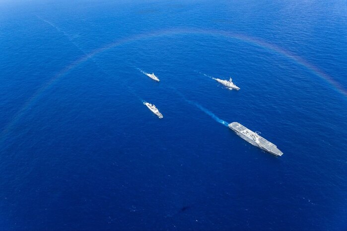 Japan Maritime Self-Defense Force Hyuga-class helicopter destroyer, JS Hyuga, leads United States Navy Arleigh Burke-class destroyer, USS Fitzgerald (centre-right), Indian Navy Shivalik-class frigate, INS Sahyadri (centre-left), and Royal Australian Navy Anzac-class frigate, HMAS Ballarat, while a Royal Australian Air Force P-8A Poseidon maritime patrol aircraft (right) and a Japan Maritime Self-Defense Force P-1 Poseidon maritime patrol aircraft fly over during Exercise MALABAR 25.