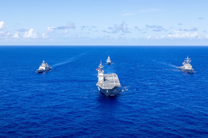 Japan Maritime Self-Defense Force Hyuga-class helicopter destroyer, JS Hyuga, leads United States Navy Arleigh Burke-class destroyer, USS Fitzgerald (centre-right), Indian Navy Shivalik-class frigate, INS Sahyadri (centre-left), and Royal Australian Navy Anzac-class frigate, HMAS Ballarat, during Exercise MALABAR 25 off the coast of Guam.