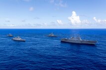 Japan Maritime Self-Defense Force Hyuga-class helicopter destroyer, JS Hyuga, leads United States Navy Arleigh Burke-class destroyer, USS Fitzgerald (centre-right), Indian Navy Shivalik-class frigate, INS Sahyadri (centre-left), and Royal Australian Navy Anzac-class frigate, HMAS Ballarat, during Exercise MALABAR 25 off the coast of Guam.