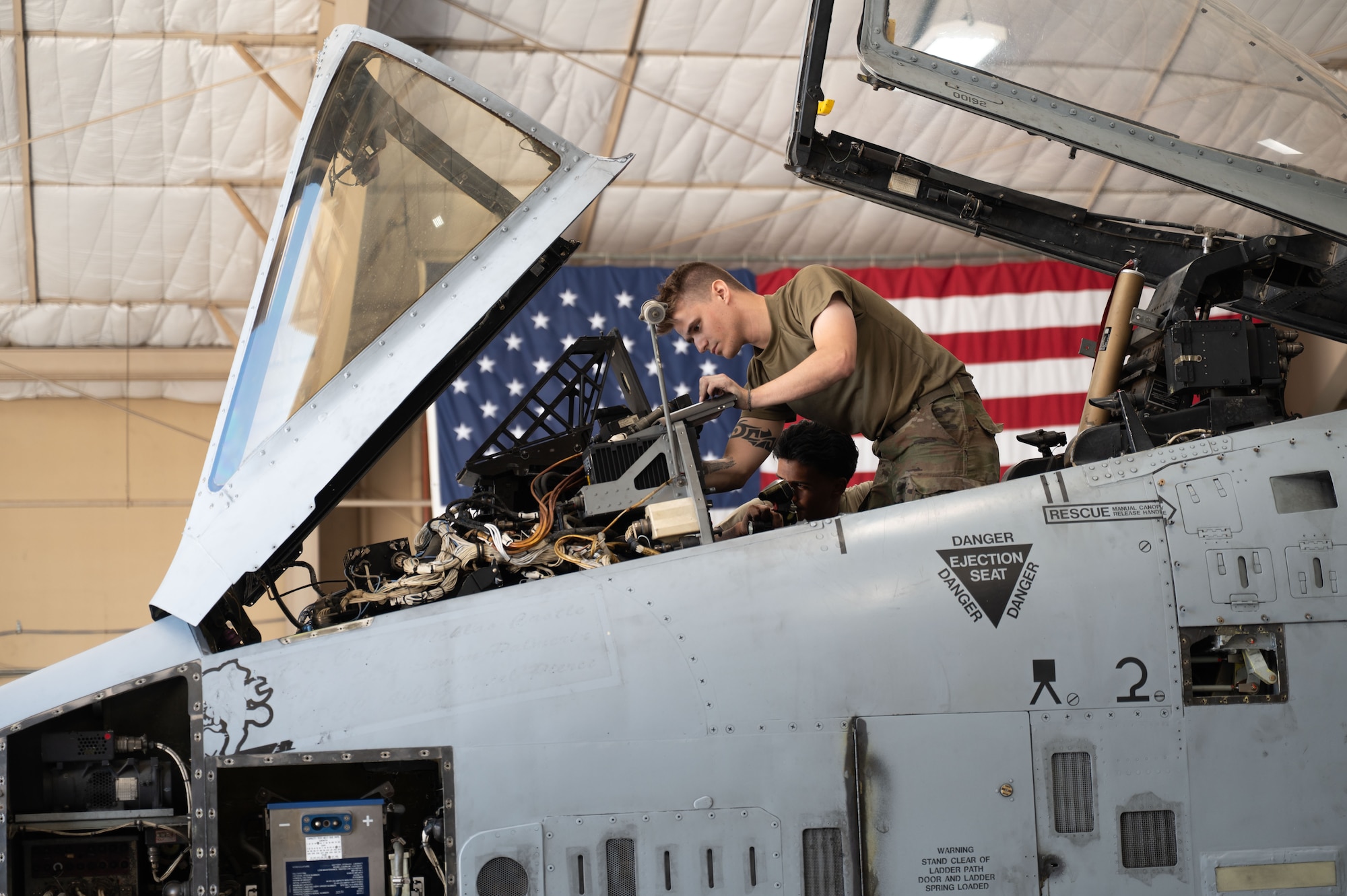 U.S. Air Force Airmen perform phase maintenance in the cockpit of an A-10C Thunderbolt II aircraft at Davis-Monthan Air Force Base, October 20, 2025. Phase maintenance is a process where the entire aircraft is taken apart, inspected, repaired and put back together. (U.S. Air Force photo by Airman 1st Class Jaden Kidd)