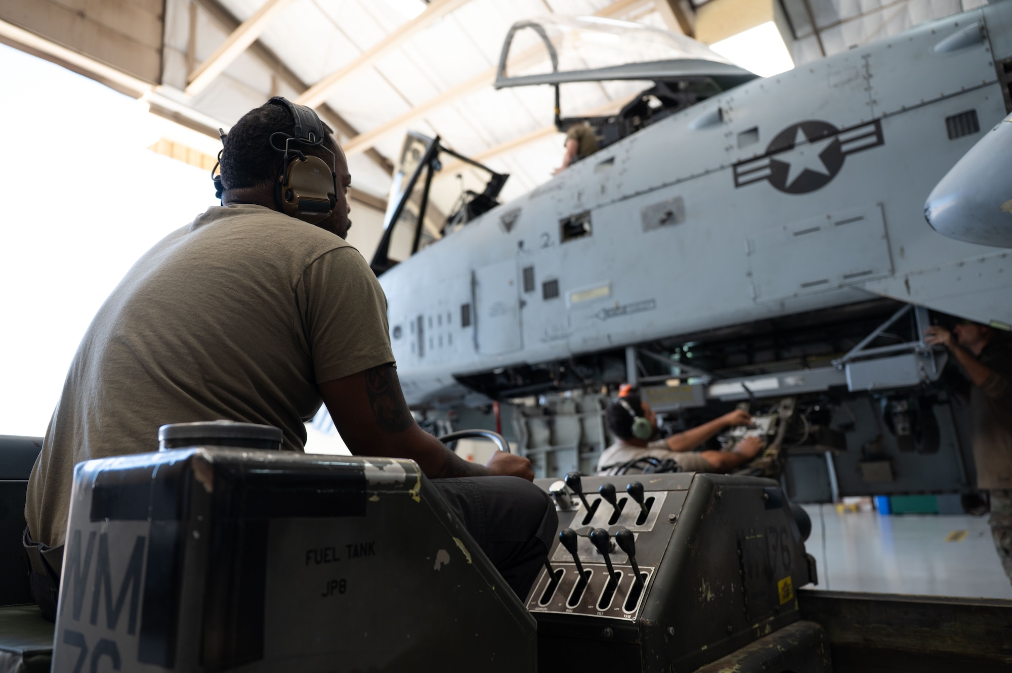 U.S. Air Force Senior Airman Austin Dyer, 357th Fighter Generation Squadron weapons load crew member, operates an MHU-83 Bomb Lift Truck during phase maintenance at Davis-Monthan Air Force Base, October 20, 2025. Phase maintenance on an A-10C Thunderbolt II aircraft can take up to two weeks of around the clock work. (U.S. Air Force photo by Airman 1st Class Jaden Kidd)