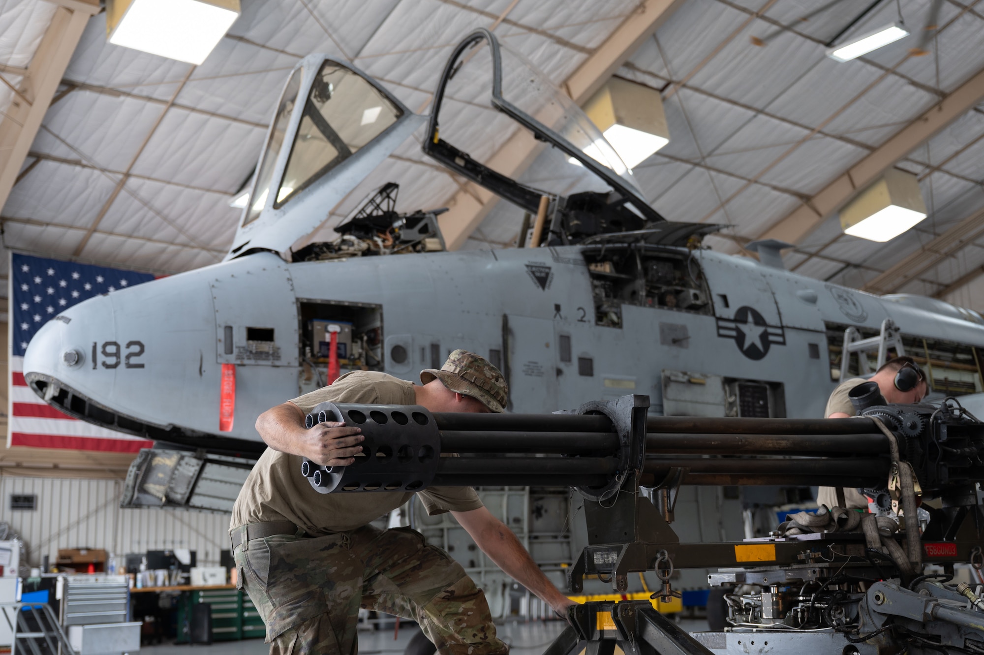 U.S. Air Force Airmen remove the GAU-8 Avenger Gatling Gun from an A-10C Thunderbolt II aircraft at Davis-Monthan Air Force Base, October 23, 2025. The Airmen worked together to remove the gatling gun in under 10 minutes, a process which typically takes an hour. (U.S. Air Force photo by Airman 1st Class Jaden Kidd)