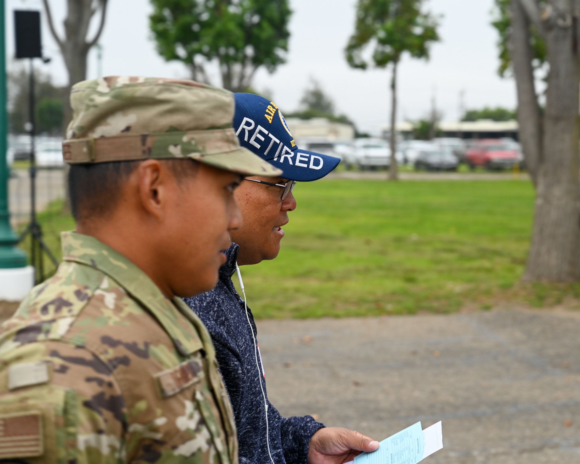 A U.S. Air Force active-duty service member from Vandenberg Space Force Base walks alongside an Air Force veteran.