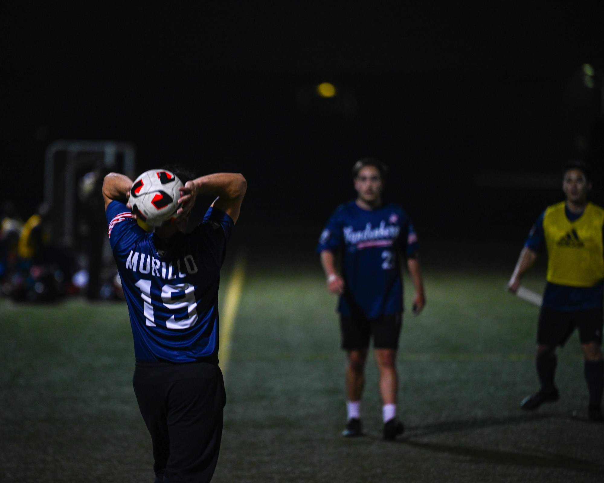 Gerardo Murillo, Space Launch Delta 30 Precision Measurement Equipment Laboratory technician, throws a soccer ball to his teammate.