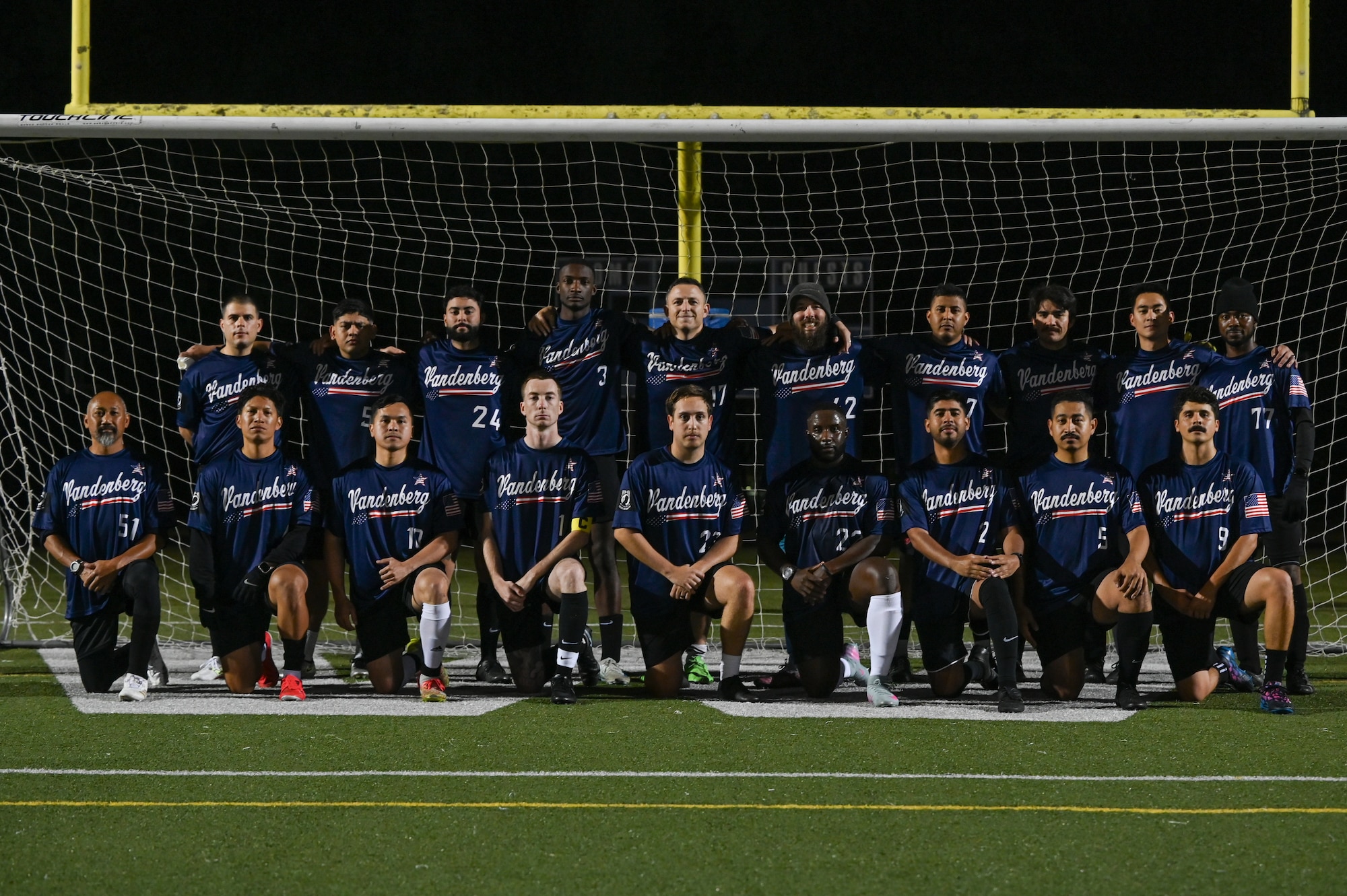 Vandenberg Space Force Base Hawks’ varsity soccer team players pose for a group photo in front of the soccer goal.