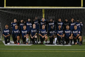 Vandenberg Space Force Base Hawks’ varsity soccer team players pose for a group photo in front of the soccer goal.