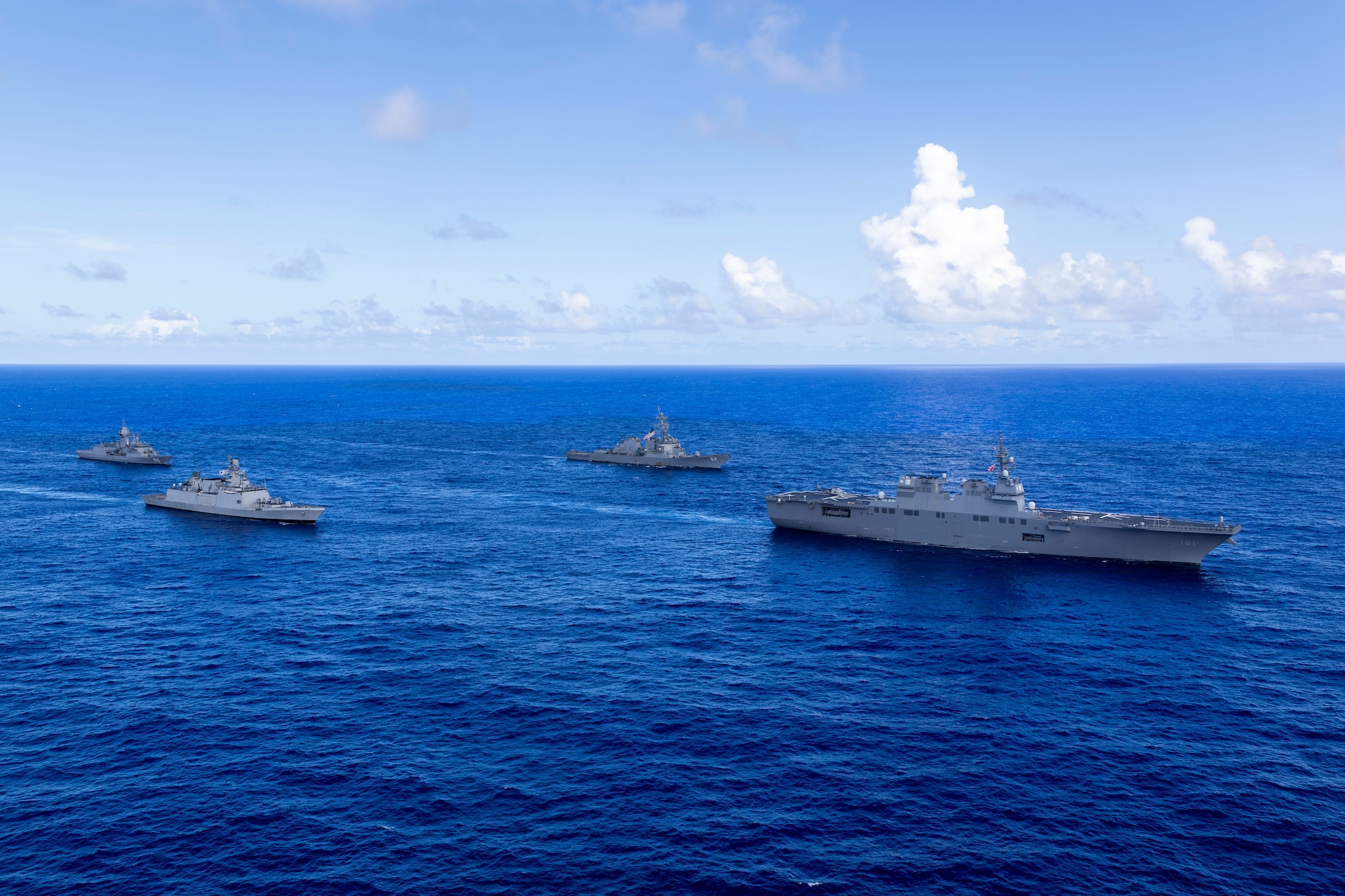 Japan Maritime Self-Defense Force Hyuga-class helicopter destroyer, JS Hyuga, leads United States Navy Arleigh Burke-class destroyer, USS Fitzgerald (centre-right), Indian Navy Shivalik-class frigate, INS Sahyadri (centre-left), and Royal Australian Navy Anzac-class frigate, HMAS Ballarat, during Exercise MALABAR 25 off the coast of Guam.
