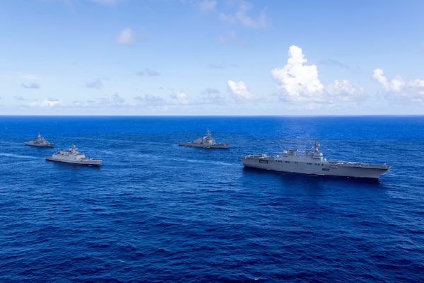 Japan Maritime Self-Defense Force Hyuga-class helicopter destroyer, JS Hyuga, leads United States Navy Arleigh Burke-class destroyer, USS Fitzgerald (centre-right), Indian Navy Shivalik-class frigate, INS Sahyadri (centre-left), and Royal Australian Navy Anzac-class frigate, HMAS Ballarat, during Exercise MALABAR 25 off the coast of Guam.