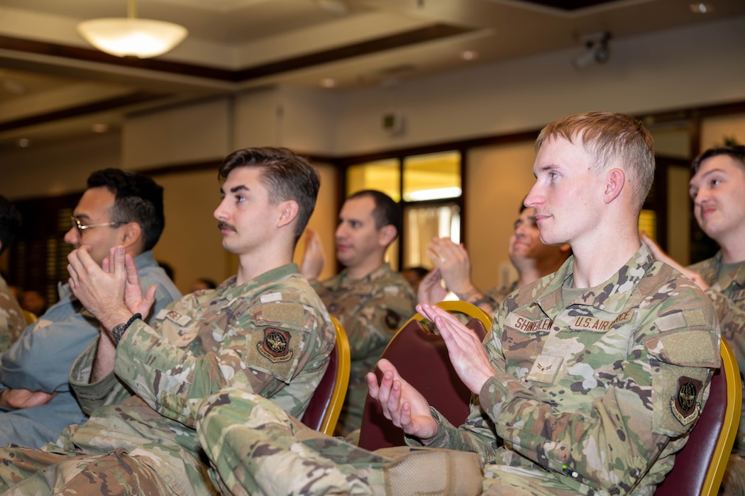 Airmen clap after a performance at an event