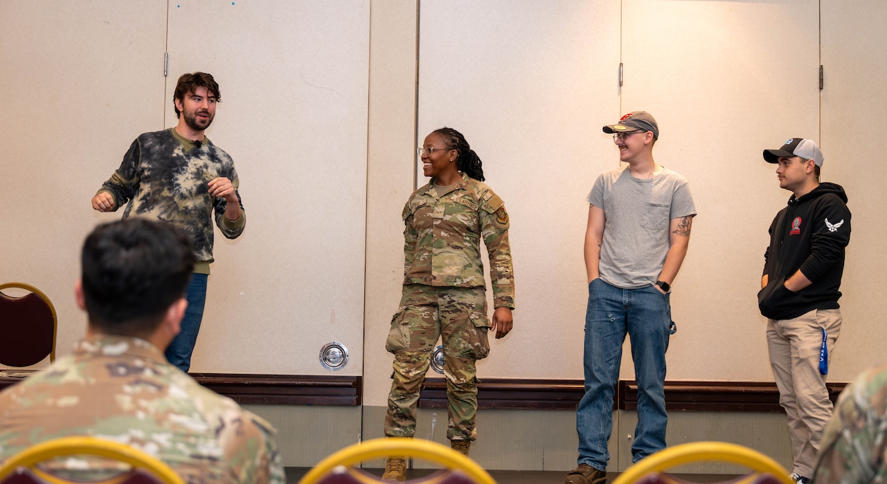 Performers act out a scene for Airmen at an event