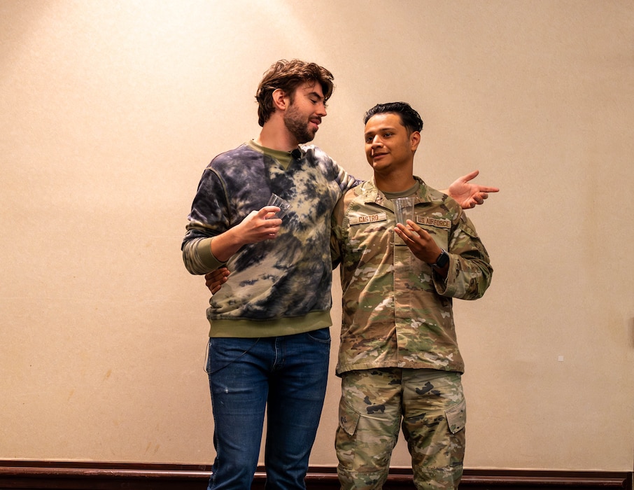 Airmen stand together on stage
