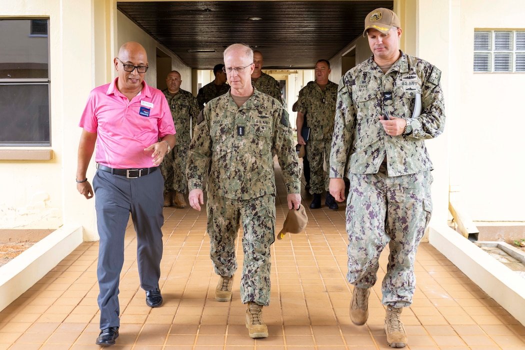 Commander, Naval Base Guam Capt. John Frye, right, and Virgilio Figueras, housing director for NBG, left, provide Chief of Naval Operations Adm. Daryl Caudle a tour of unaccompanied housing on NBG, Nov. 19.
