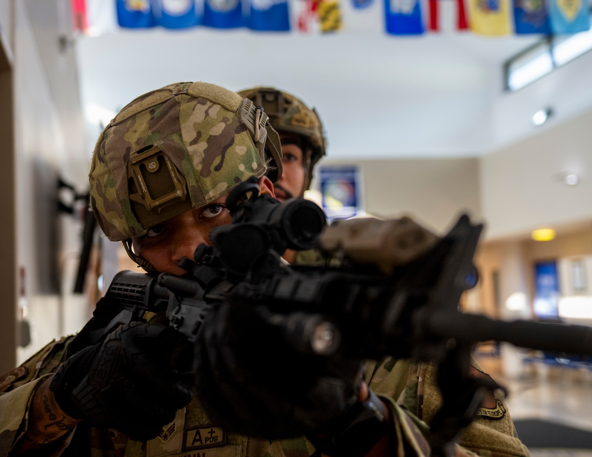 A service member clears a hallway