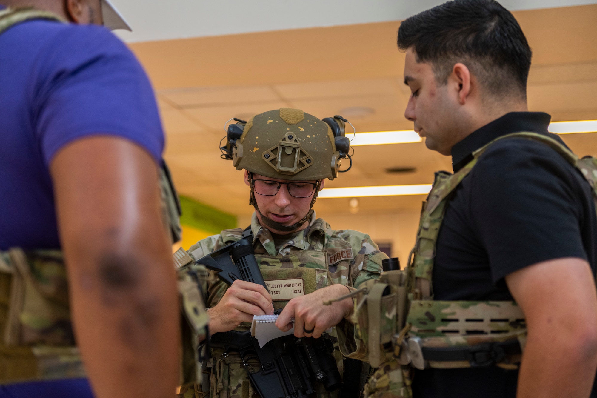 A service member writes participates information down