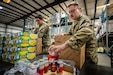 U.S. Army Staff Sgt. Brandon Tagarook, left, of the Kentucky Army National Guard’s 202nd Army Band, and U.S. Air Force Tech. Sgt. Alex Koehler of the Kentucky Air National Guard’s 123rd Contingency Response Group pack boxes with free groceries at the Dare to Care Food Bank in Louisville, Ky., Nov. 13, 2025. The boxes, containing canned fruit and vegetables, peanut butter, pasta and other nutritious foods, will be given to Kentuckians who are struggling to purchase basic groceries. (U.S. Air National Guard photos by Dale Greer)