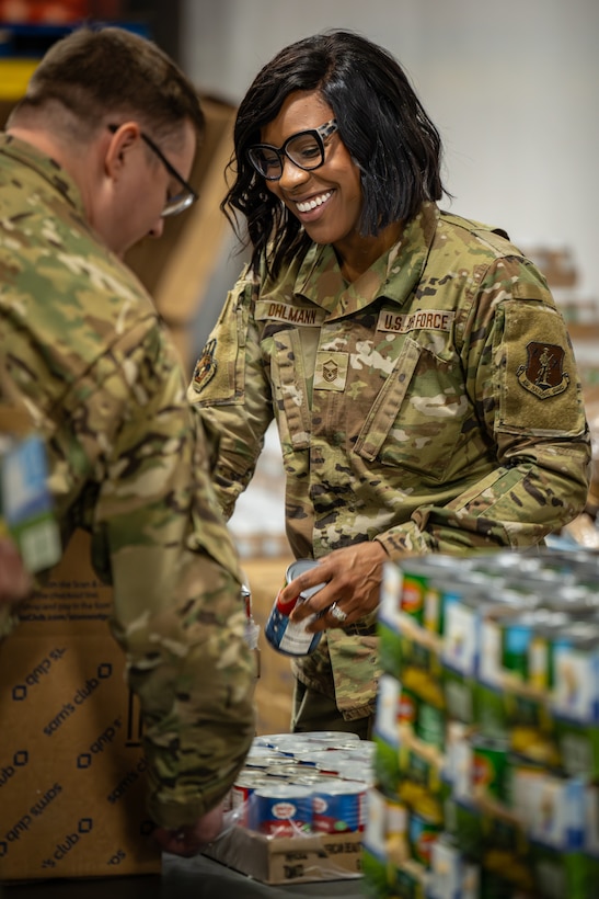 U.S. Air Force Master Sgt. Latrice Ohlmann from the Kentucky Air National Guard’s 123rd Medical Group packs boxes with free groceries at the Dare to Care Food Bank in Louisville, Ky., Nov. 13, 2025. The boxes, containing canned fruit and vegetables, peanut butter, pasta and other nutritious foods, will be given to Kentuckians who are struggling to purchase basic groceries. (U.S. Air National Guard photos by Dale Greer)