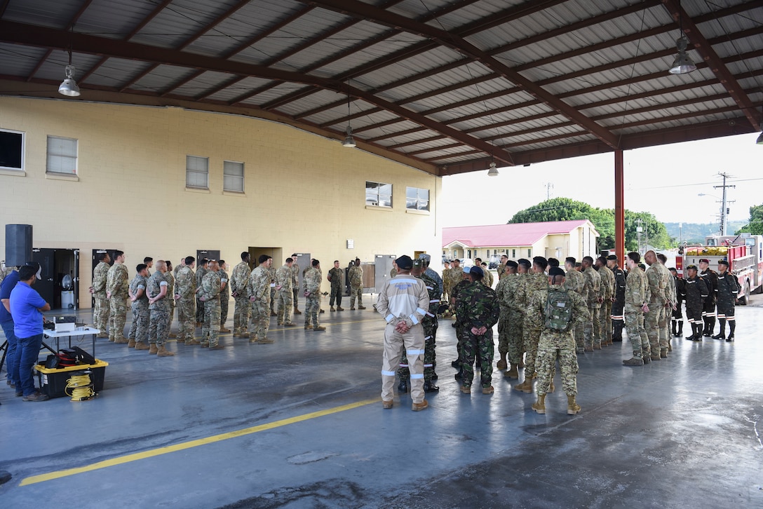 People in military uniform stand in formation