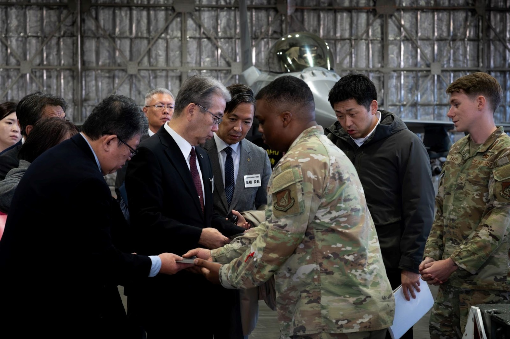 U.S. Airmen assigned to the 35th Fighter Wing pass around aircraft fin parts to Tohoku Defense Bureau members during a tour at Misawa Air Base, Japan, Nov. 5, 2025.