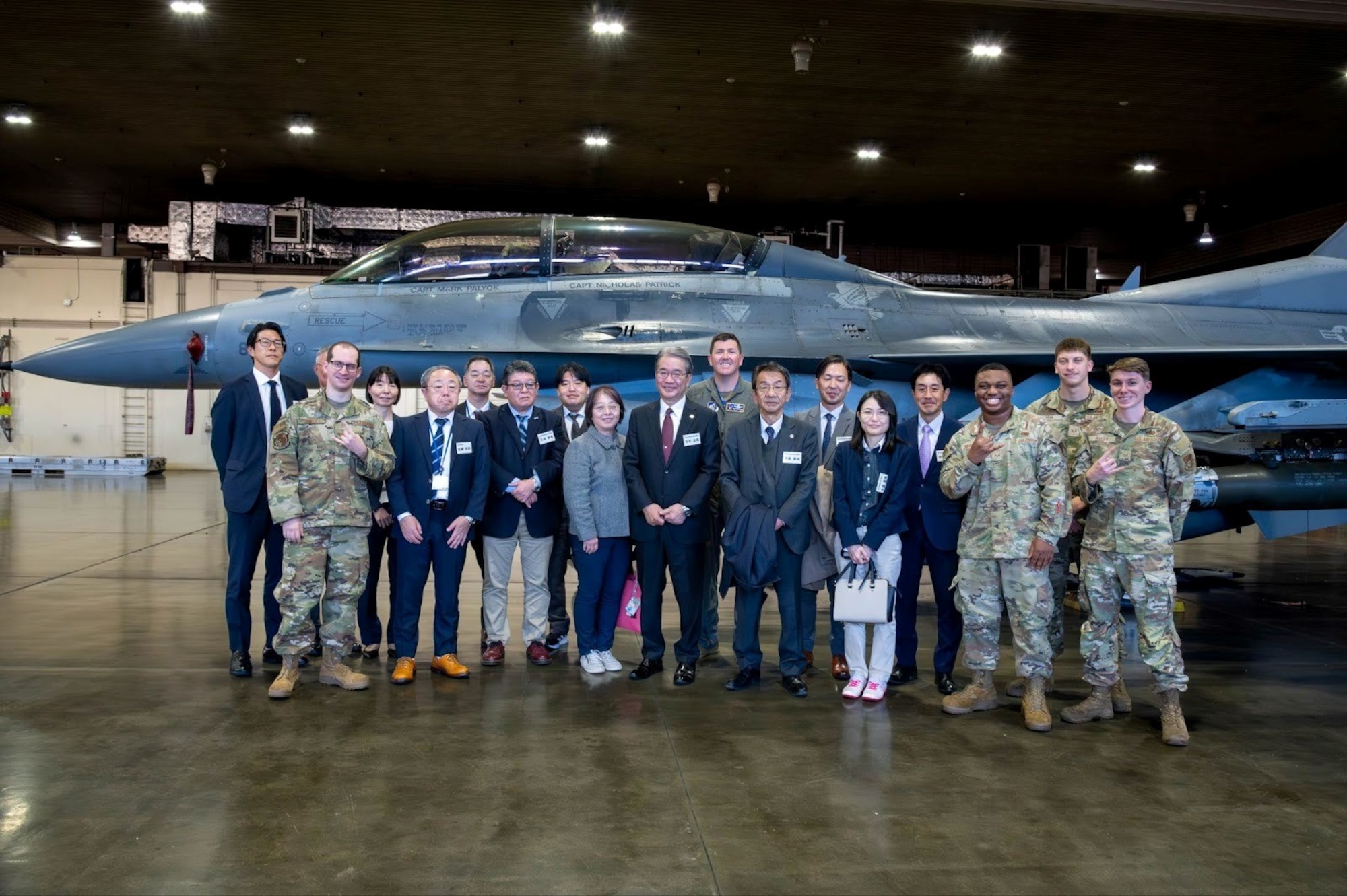 U.S. Airmen assigned to the 35th Fighter Wing and Japanese Tohoku Defense Bureau members pose for a group photo in front of a U.S. Air Force F-16 Fighting Falcon assigned to the 14th Fighter Squadron during a tour at Misawa Air Base, Japan, Nov. 5, 2025.