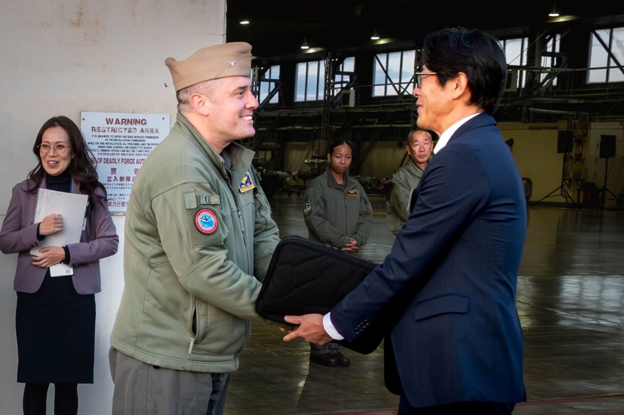 U.S. Navy Capt. Jeremy Lyon, Naval Air Facility Misawa commander, and a Tohoku Defense Bureau member shake hands during a visit at Misawa Air Base, Japan, Nov. 5, 2025.