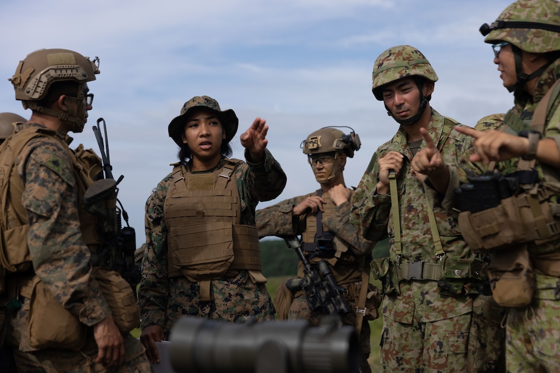 U.S. Marine Corps Lance Cpl. Kaiesha Deweever, an admin specialist with the 1st Marine Aircraft Wing translates during a live-fire range as part of exercise Resolute Dragon 25 on Oyanohara Manuver Area, Oita Prefecture, Japan, Sept. 13, 2025. Resolute Dragon is an annual bilateral exercise in Japan that strengthens the command, control, and multi-domain maneuver capabilities of U.S. Marines in III Marine Expeditionary Force and Japan Self-Defense Force personnel, with a focus on controlling and defending key maritime terrain. Deweever is a native of Hawaii. (U.S. Marine Corps photo by Lance Cpl. Robert Blanks)