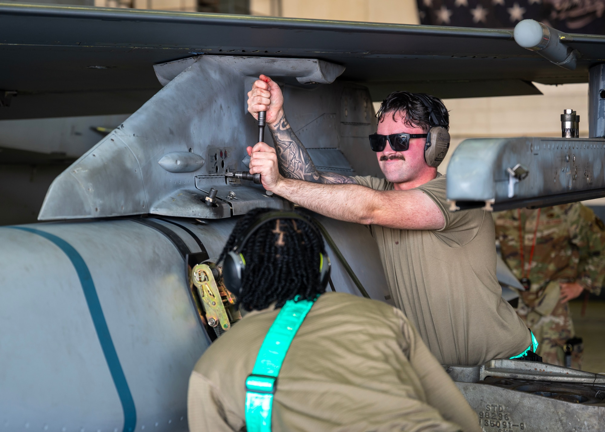 U.S. Air Force Airman 1st Class Sean McDermott, 51st Maintenance Group/Operating Location weapons load crew member, tightens a bolt during a weapons loading competition at Osan Air Base, Republic of Korea, Oct. 2, 2025. The competition prepared Airmen to execute Osan’s “Fight Tonight” mission anytime, anywhere. (U.S. Air Force photo by Staff Sgt. Sarah Williams)