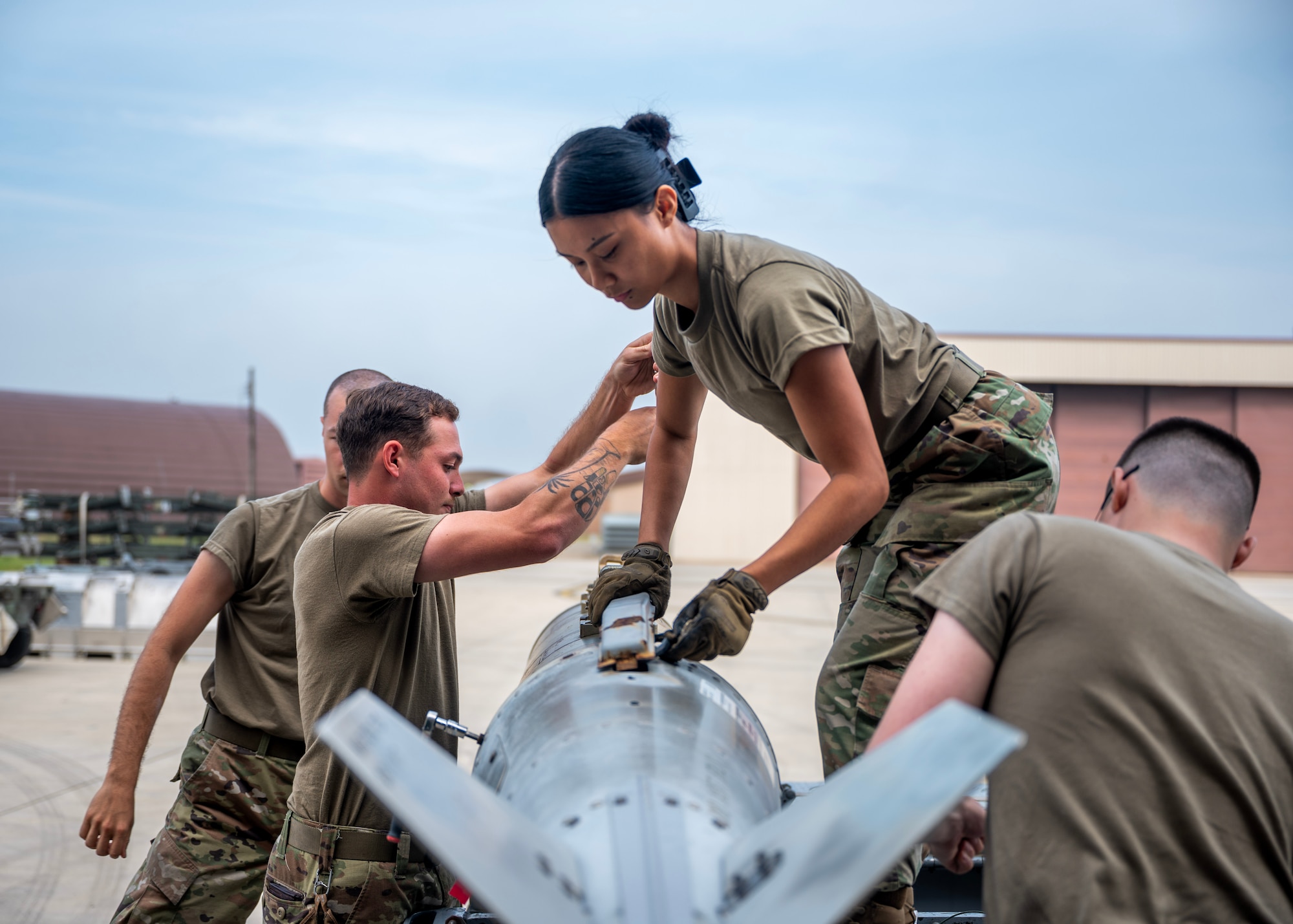 Airmen assigned to the 51st Munitions Squadron prepare munitions during a quarterly load crew competition at Osan Air Base, Republic of Korea, Oct. 2, 2025. The competition challenged Airmen to rapidly and safely assemble munitions under strict time constraints. (U.S. Air Force photo by Staff Sgt. Sarah Williams)